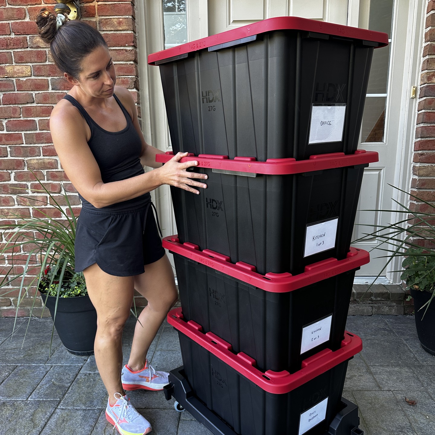 Loading a stack of moving totes onto a rolling dolly